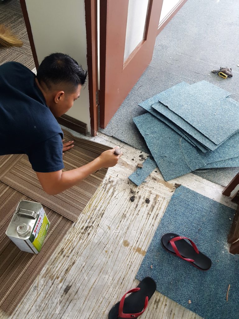 New carpet tiles installation in-progress