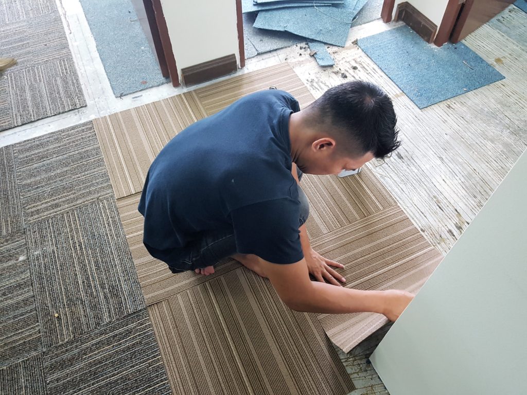 New carpet tiles installation in-progress