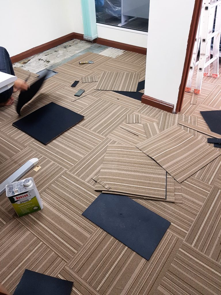 New carpet tiles installation in-progress