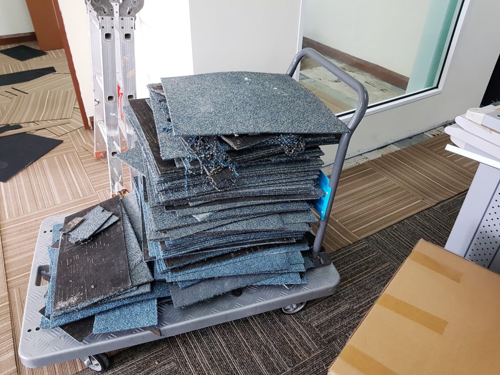 Old carpet tiles transported out