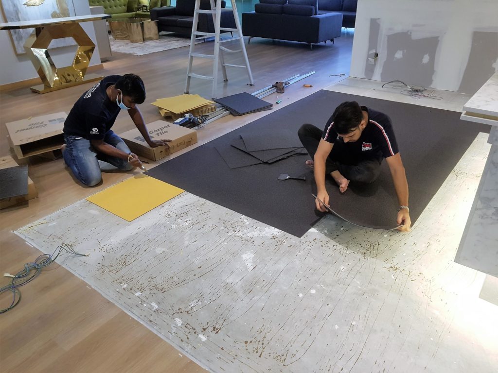 Carpet Tiles being laid.