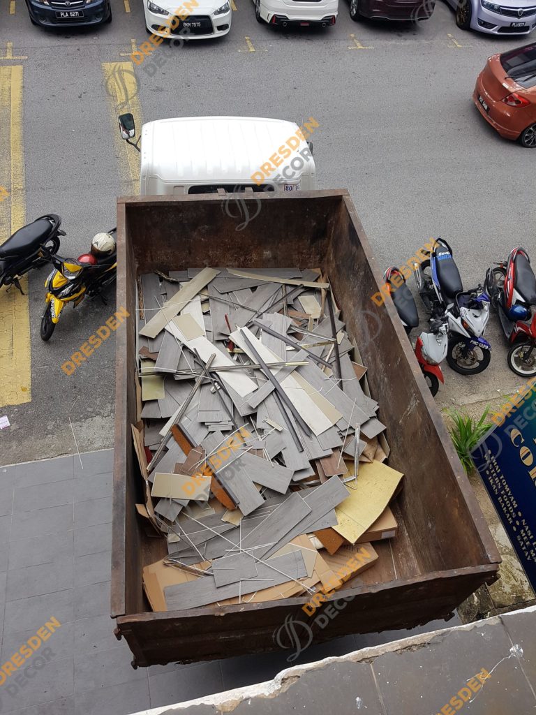 Existing SPC Flooring being removed and transported our for disposal.